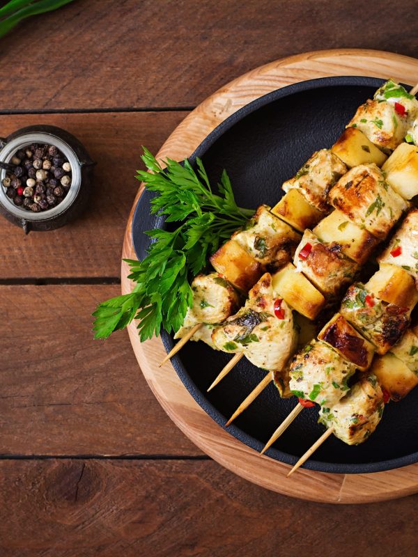 Chicken skewers with slices of apples and chili. Top view